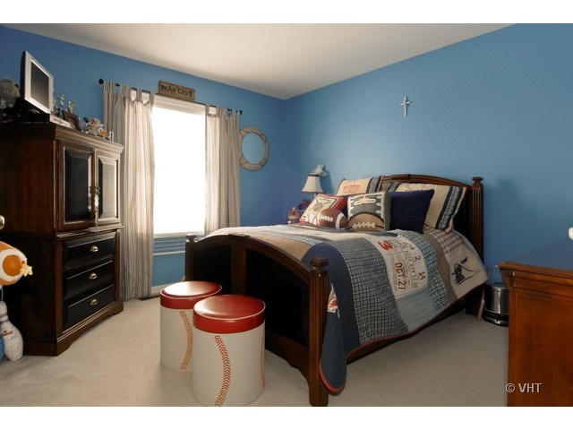 655 Ridge Drive Elburn, IL 60119 - Photo 13 of 16 a bedroom with a bed and wooden floor