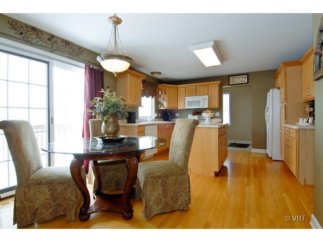 655 Ridge Drive Elburn, IL 60119 - Photo 4 of 16 a view of a dining room with furniture window and wooden floor