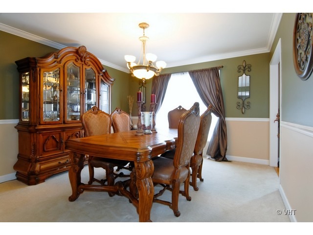 655 Ridge Drive Elburn, IL 60119 - Photo 5 of 16 a view of a dining room with furniture and a chandelier