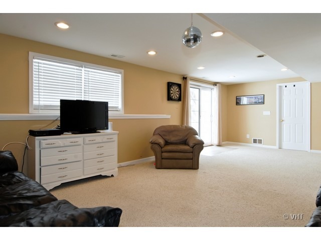 655 Ridge Drive Elburn, IL 60119 - Photo 7 of 16 a living room with furniture flat screen tv and window