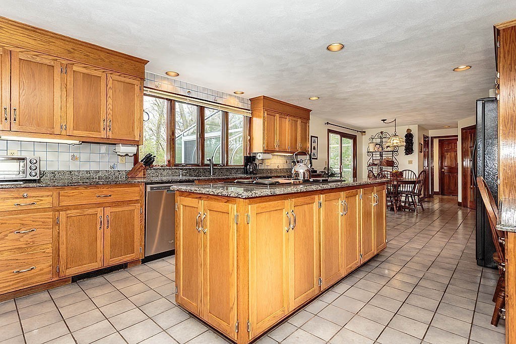 65 Porter Road Boxford, MA 01921 - Photo 8 of 30 a kitchen with stainless steel appliances granite countertop a stove a sink and a refrigerator