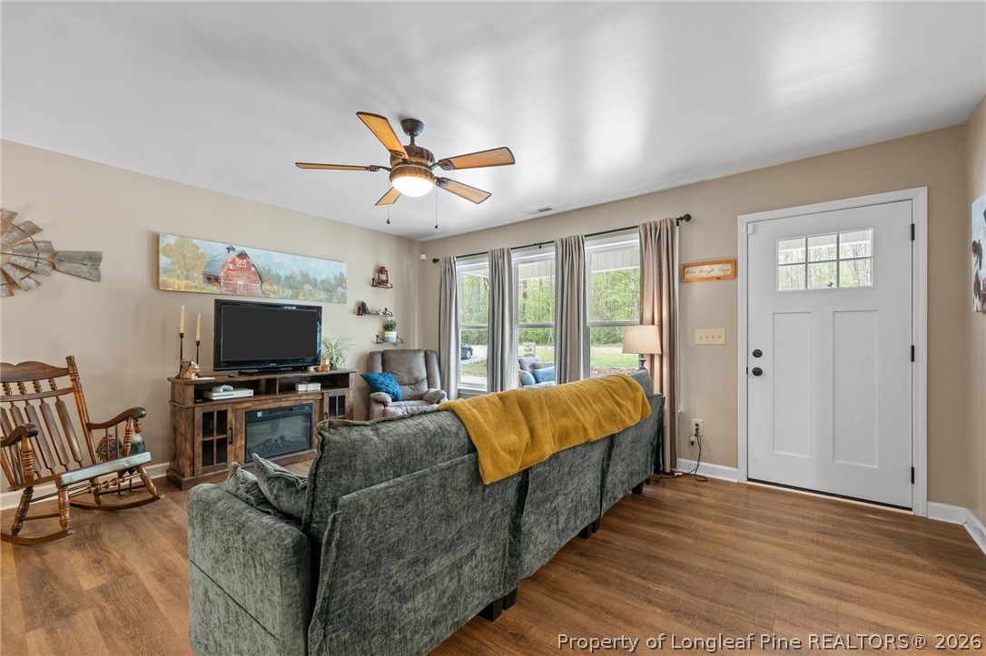 186 Lewis Brown Road Bennett, NC 27208 - Photo 6 of 48 a living room with furniture a ceiling fan and a flat screen tv