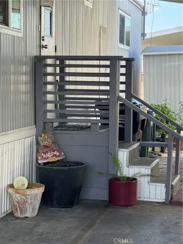 a building outdoor space with patio furniture and potted plants