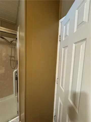 a bathroom with a glass door shower
