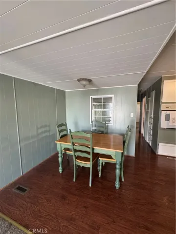 a dining room with furniture and wooden floor