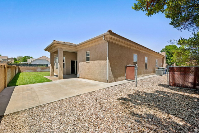 2226 East 140 South St. George, UT 84790 - Photo 17 of 20 Rear exterior featuring a covered patio, concrete slab, and a gravel-covered side yard