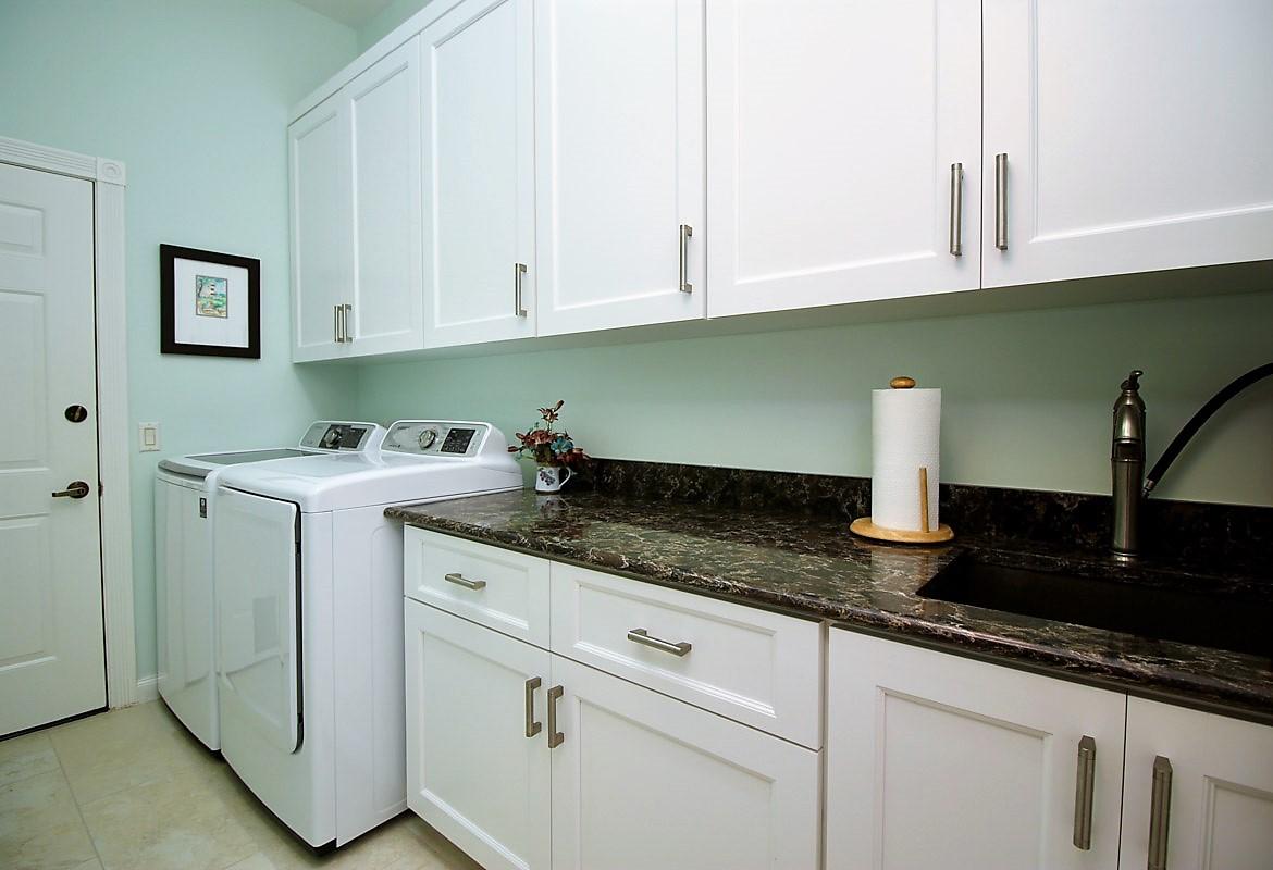 127 Hampton Circle Jupiter, FL 33458 - Photo 21 of 31 Laundry Room w/ Sink and Storage