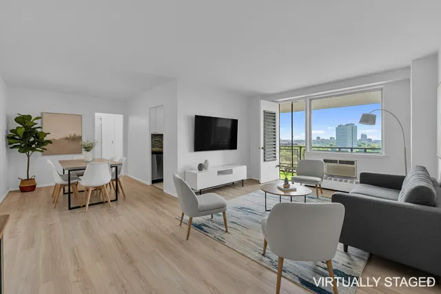a living room with furniture a flat screen tv and a large window