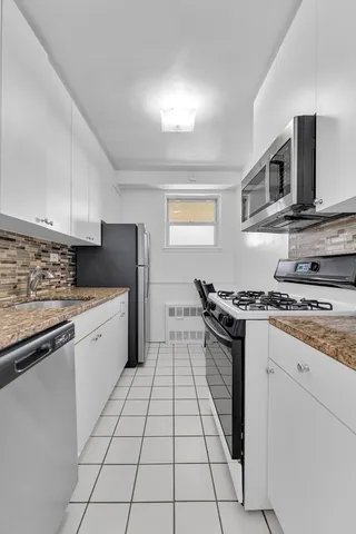 a view of wooden floor and a kitchen