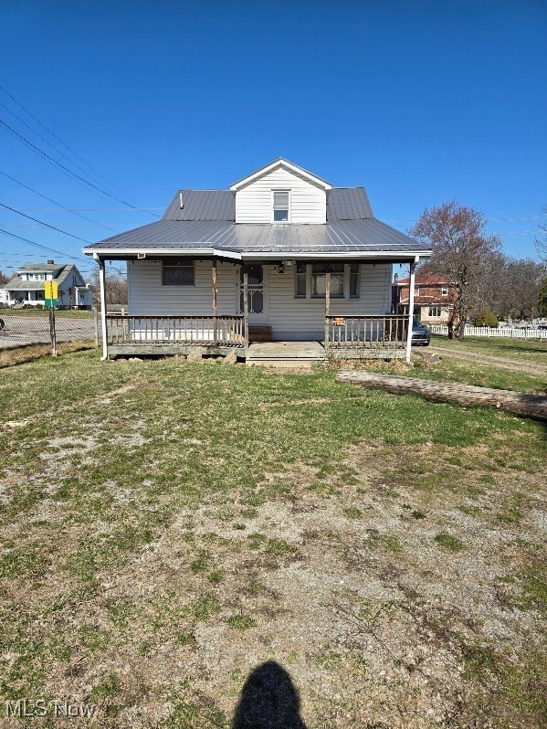 125 Rockdale Road Follansbee, WV 26037 - Photo 16 of 19 Rear view of property featuring a metal roof, a porch, and a yard