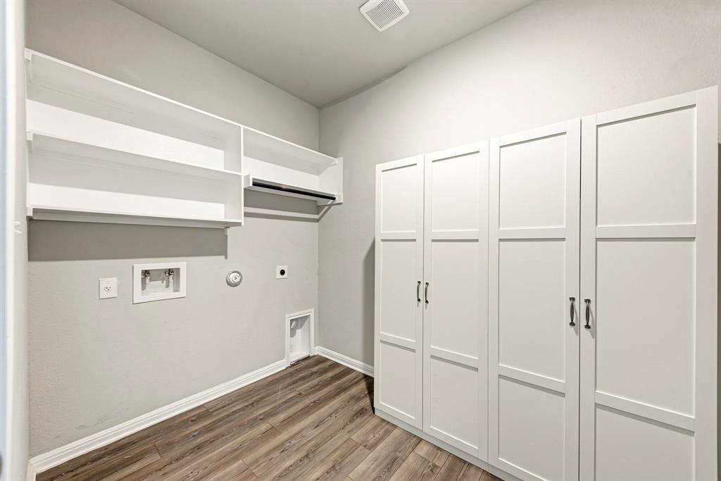 518 Windy Reed Road Hutto, TX 78634 - Photo 24 of 30 Laundry room features additional storage, shelving and convenient clothes hanging area.