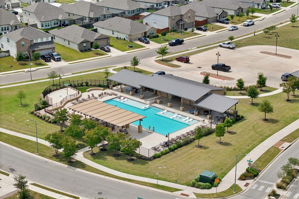 518 Windy Reed Road Hutto, TX 78634 - Photo 28 of 30 The community amenity center features a large pool, splash pad, large covered sitting areas and plenty of sunning chairs.