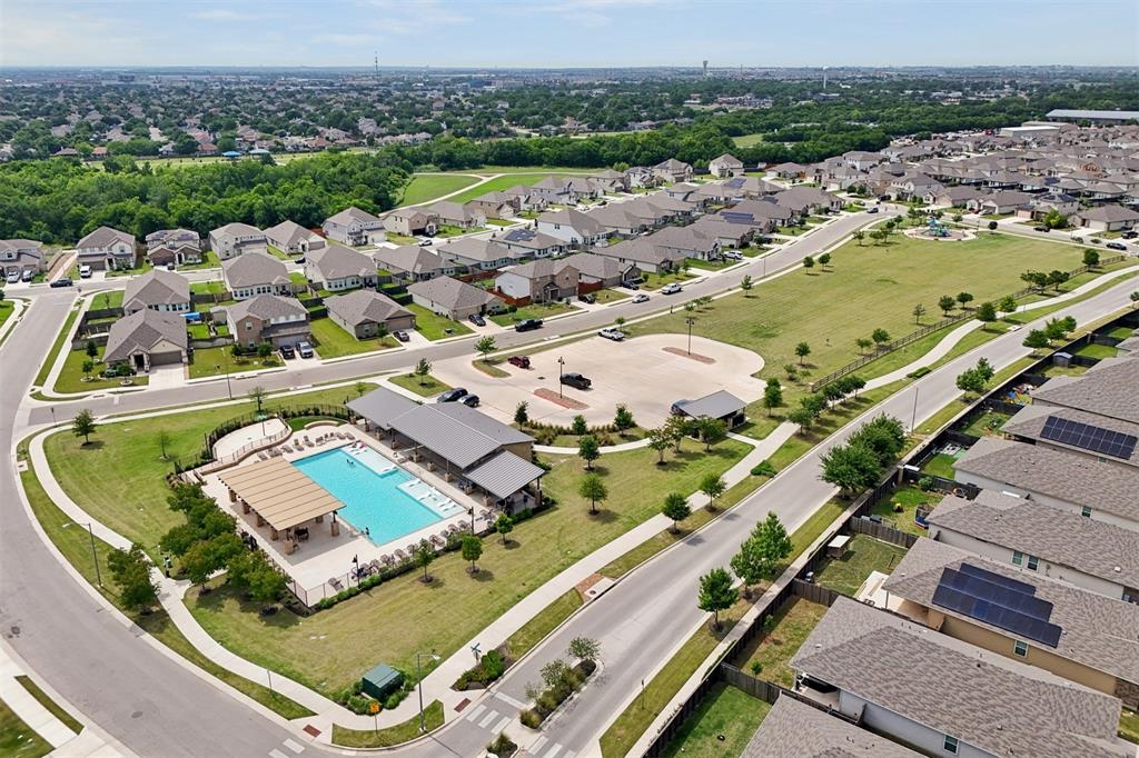 518 Windy Reed Road Hutto, TX 78634 - Photo 29 of 30 The community amenity center features a large pool, splash pad, large covered sitting areas and plenty of sunning chairs.