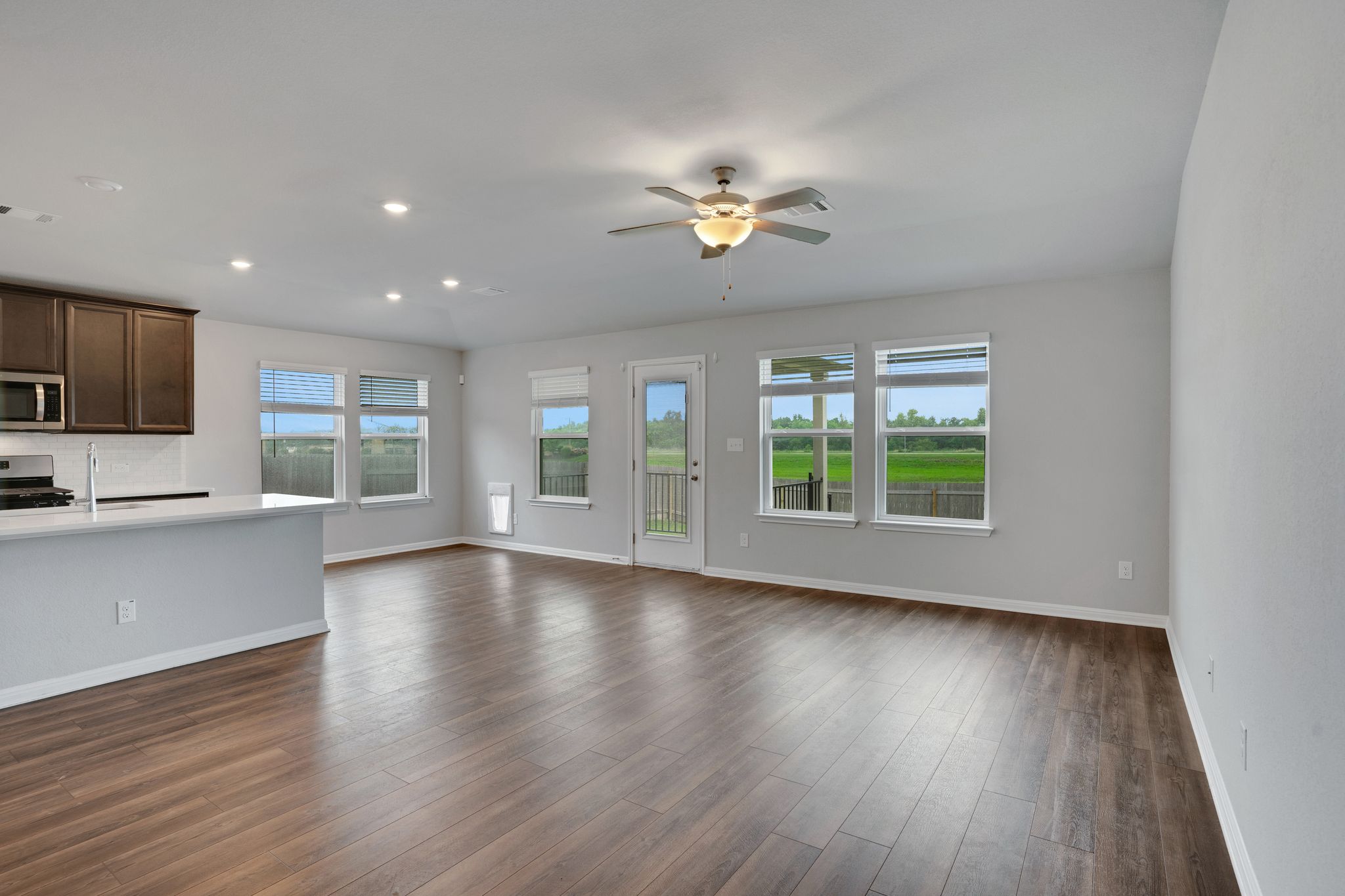 518 Windy Reed Road Hutto, TX 78634 - Photo 3 of 30 Plenty of light enters fro the back windows which overlook the peaceful green area.