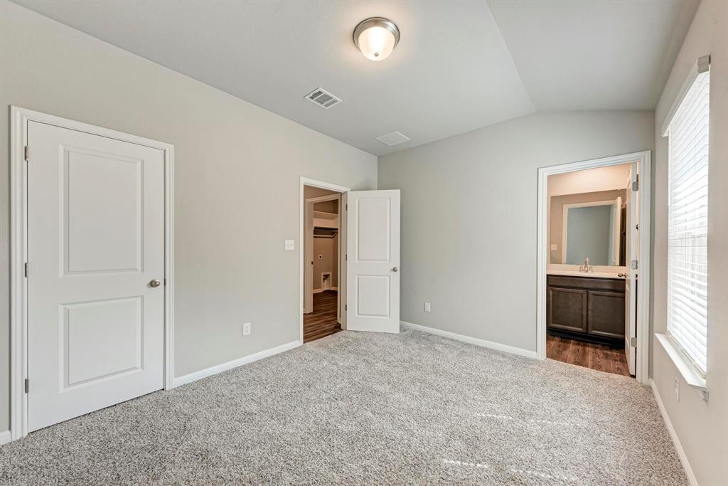 518 Windy Reed Road Hutto, TX 78634 - Photo 8 of 30 Large secondary bedroom features an en-suite full bathroom perfect for multi-generational living or a fantastic guest suite.