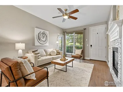 a living room with furniture a fireplace and a window