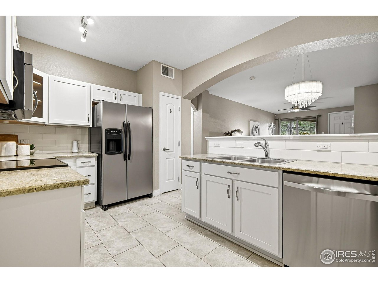 159 Quebec Street, Unit D Denver, CO 80220 - Photo 22 of 49 a kitchen with a sink stove and refrigerator