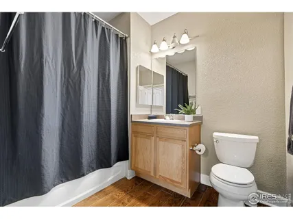 a bathroom with a toilet a sink and a mirror