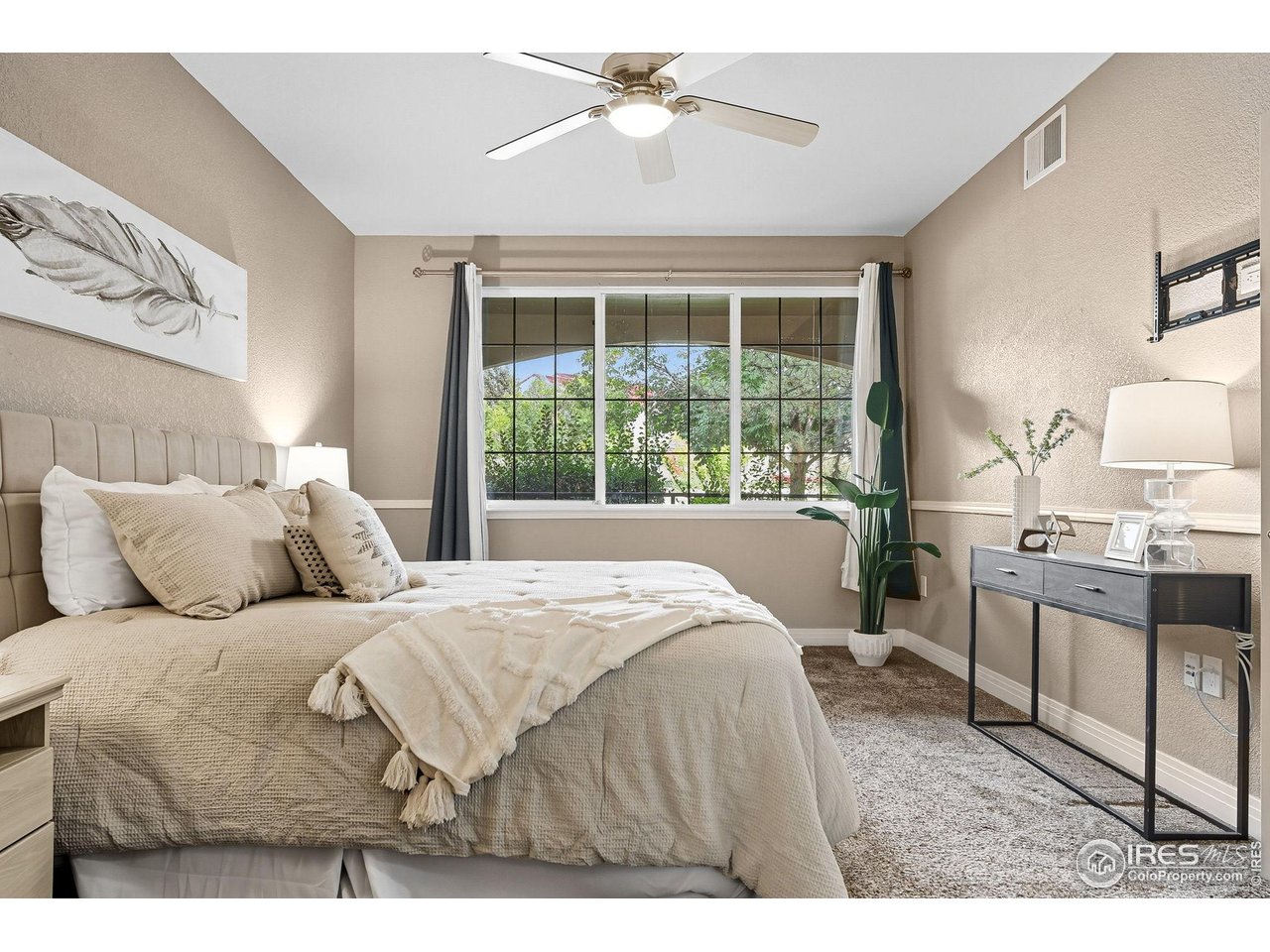 159 Quebec Street, Unit D Denver, CO 80220 - Photo 33 of 49 a bedroom with a large bed and a chandelier fan