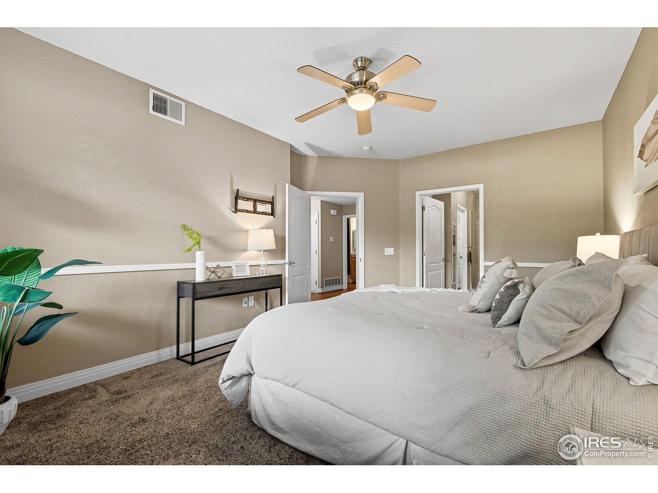 159 Quebec Street, Unit D Denver, CO 80220 - Photo 34 of 49 a bedroom with a bed and a chandelier