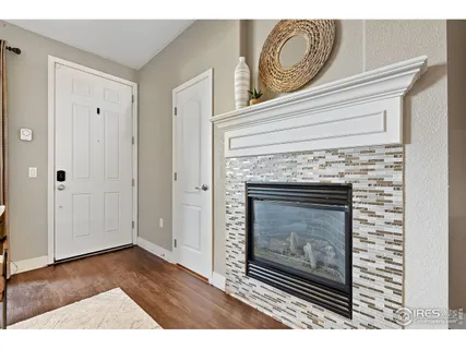 a view of a livingroom with a fireplace wooden floor and cabinet