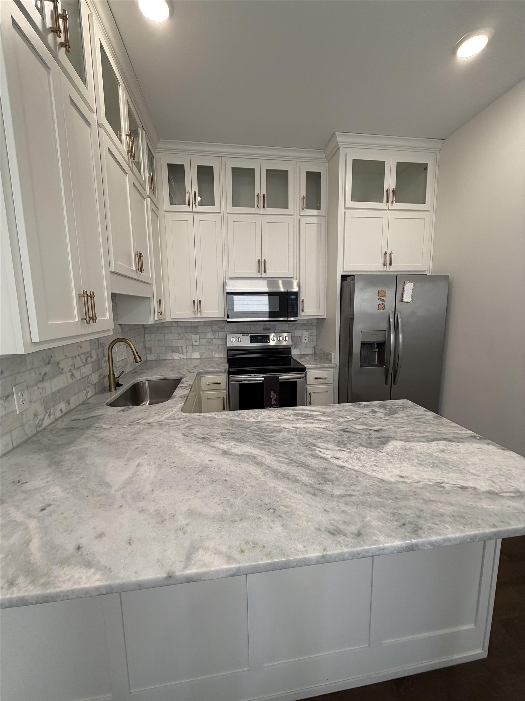 147 Greeff Lane Memphis, TN 38111 - Photo 13 of 23 a kitchen with granite countertop a refrigerator and a sink