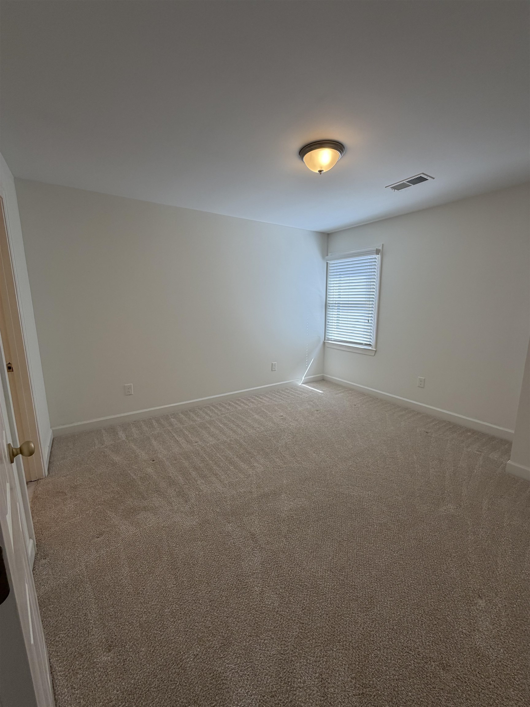 147 Greeff Lane Memphis, TN 38111 - Photo 21 of 23 an empty room with a light and a window