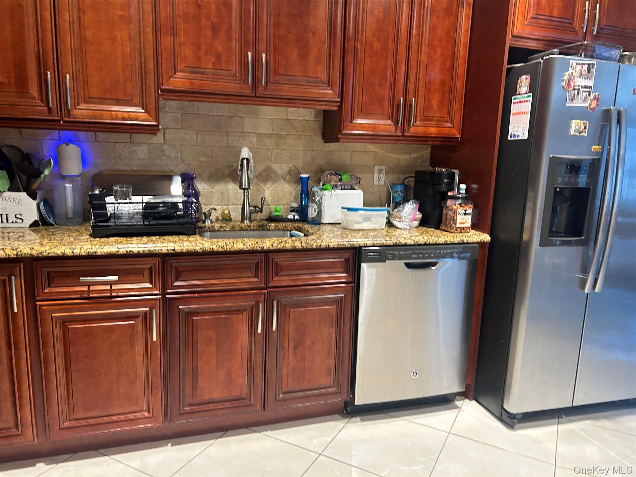 57 Woodruff Avenue Bronxville, NY 10708 - Photo 5 of 6 a kitchen with granite countertop stainless steel appliances a refrigerator and a sink