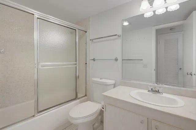 a bathroom with a toilet a sink and a mirror