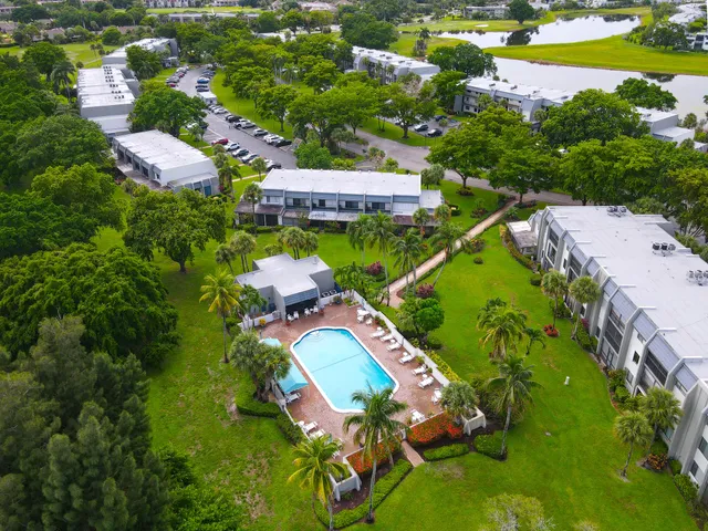 an aerial view of a house with a swimming pool yard and outdoor seating