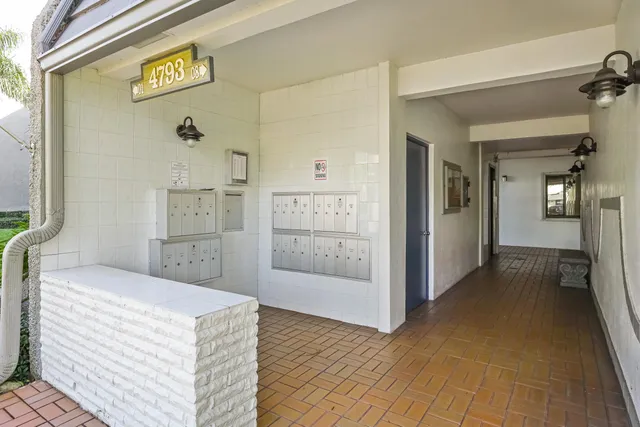 a bedroom with a bed and glass door