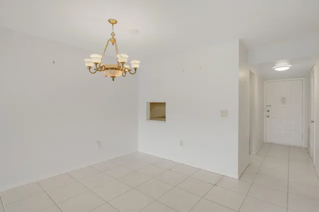en empty room with wooden floor and white walls