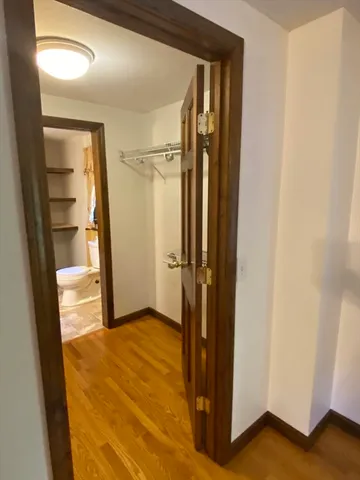 a bedroom with double bed and a dresser