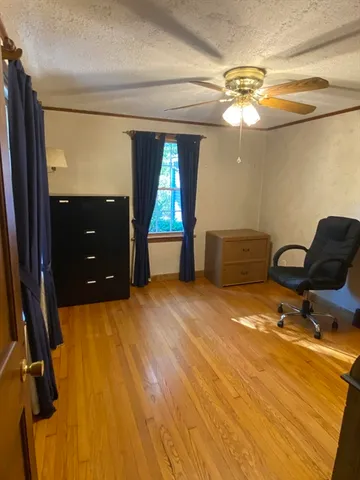 a bathroom with a granite countertop sink mirror vanity and toilet