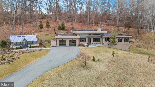an aerial view of a house with a swimming pool