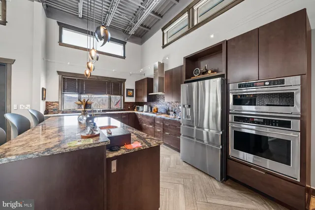 a spacious bathroom with a double vanity sink a mirror and a bathtub