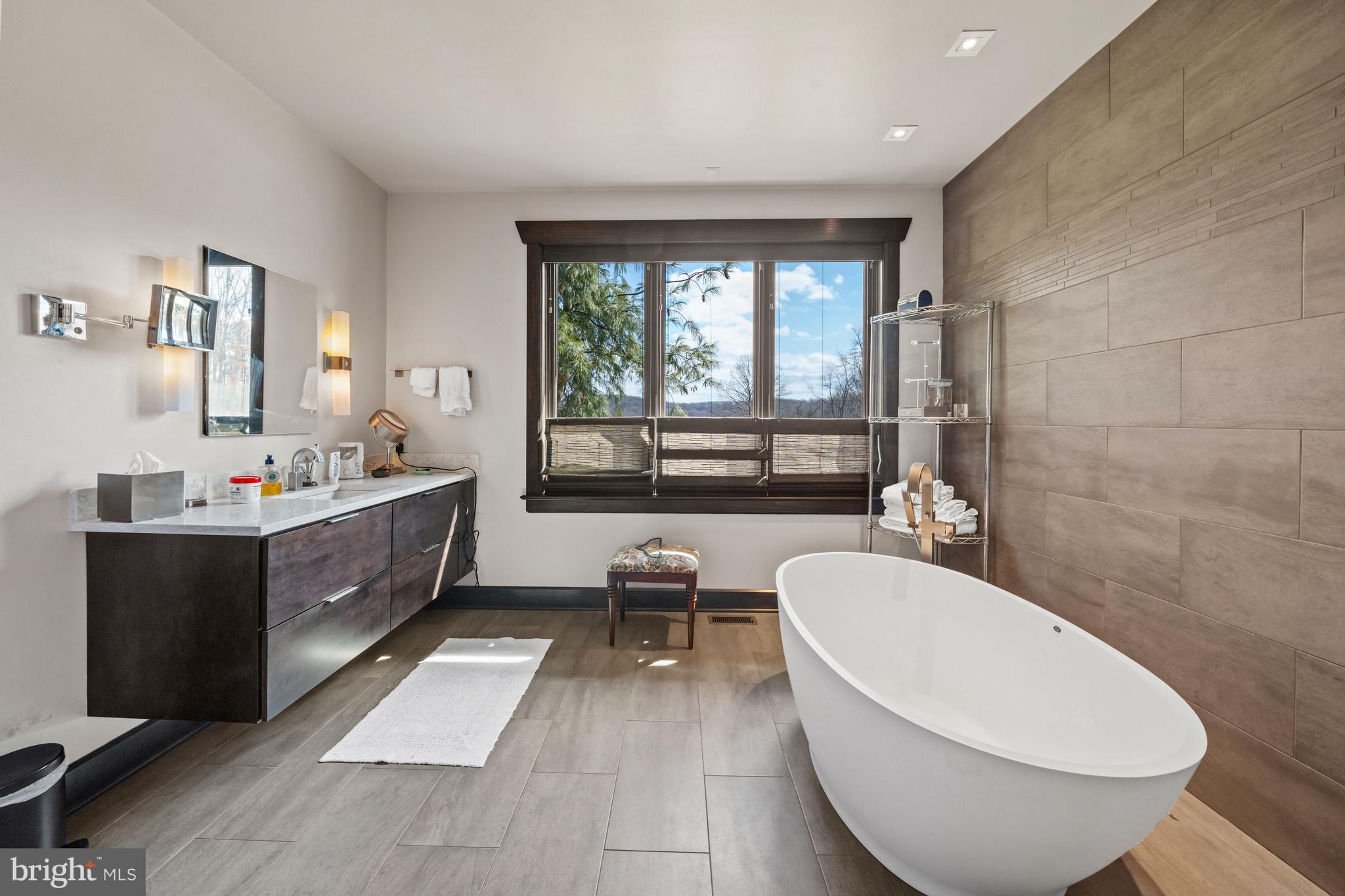 3924 Thompsons Bridge Road Wilmington, DE 19807 - Photo 23 of 78 a spacious bathroom with a double vanity sink a mirror and a bathtub
