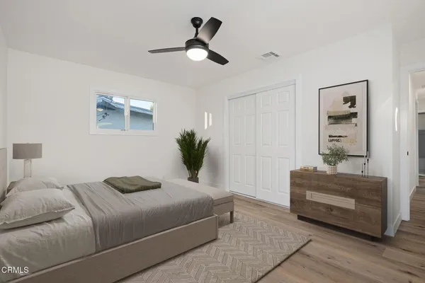 a bedroom with a bed and ceiling fan