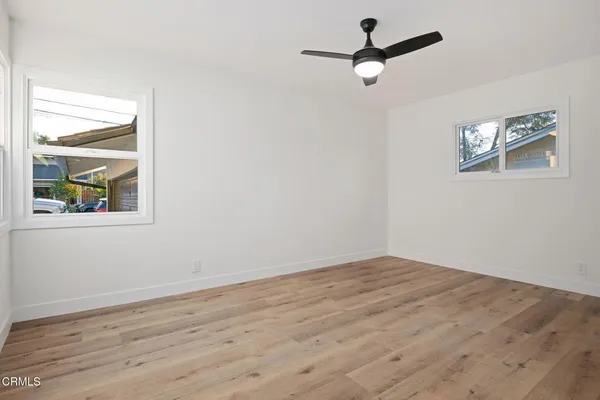 a view of empty room with wooden floor