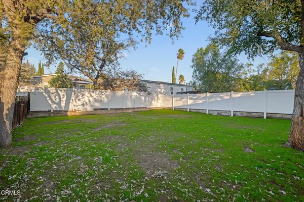 a view of yard with swimming pool and trees