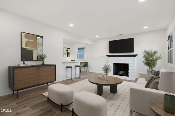 a living room with furniture a fireplace and a flat screen tv