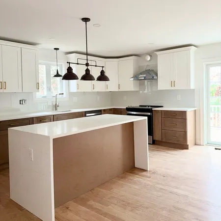 a kitchen with stainless steel appliances a sink a stove a refrigerator and cabinets