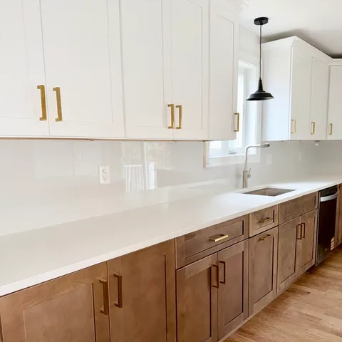 a kitchen with sink cabinets and window