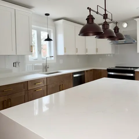 a kitchen with sink cabinets and window