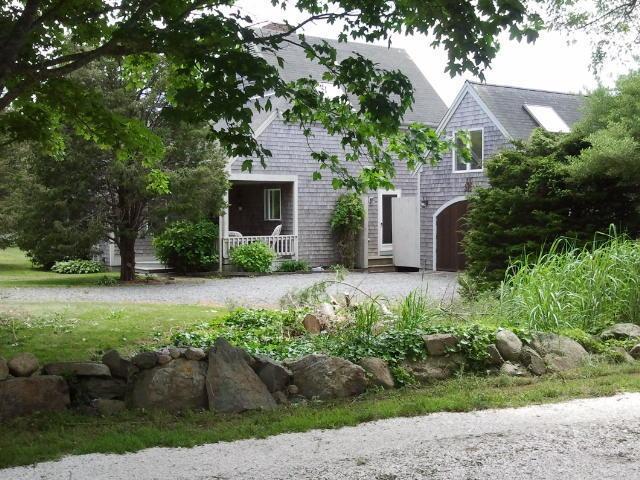 18 Cedar Land Road Orleans, MA 02653 - Photo 1 of 27 a front view of a house with garden