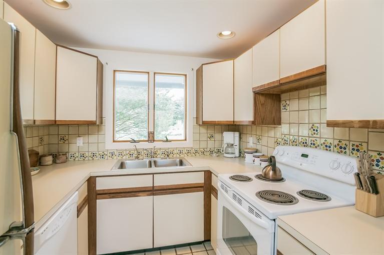 18 Cedar Land Road Orleans, MA 02653 - Photo 13 of 27 a kitchen that has a sink a stove and a refrigerator