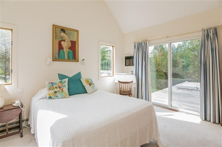 18 Cedar Land Road Orleans, MA 02653 - Photo 14 of 27 a bedroom with a balcony a bed and a large window