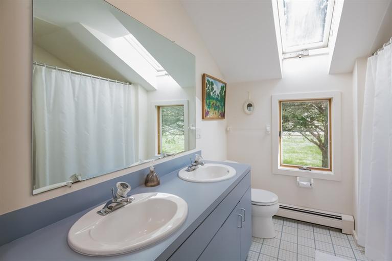18 Cedar Land Road Orleans, MA 02653 - Photo 16 of 27 a bathroom with a toilet sink and mirror