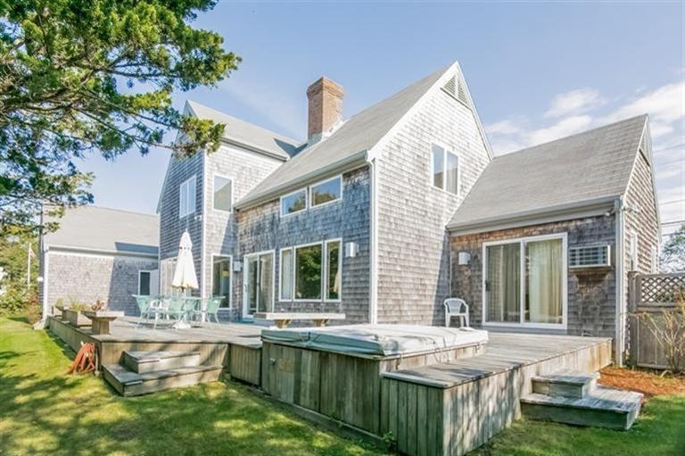 18 Cedar Land Road Orleans, MA 02653 - Photo 21 of 27 a front view of house with yard outdoor seating and barbeque oven