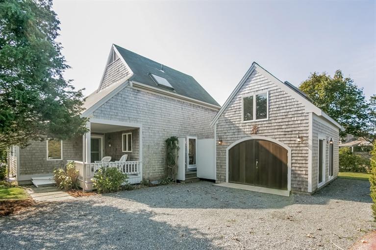 18 Cedar Land Road Orleans, MA 02653 - Photo 4 of 27 a front view of a house with a yard and garage